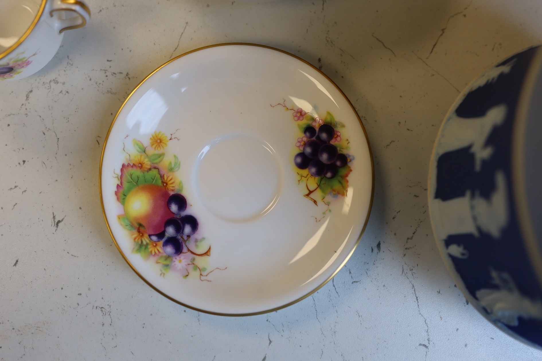 A Wedgwood three colour biscuit barrel with plated rim and handle, a Royal Worcester cup and saucer and a Dresden shaped bowl, biscuit barrel 17cm high. Condition - good